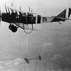1921: A biplane suspends a model wing during a test flight in June 1921. (NASA Archives)