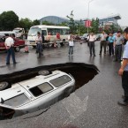 The cave-in occurred on Tuesday morning after long-term rainfall, injuring the driver. (Photo by He Zhiqin/ChinaFotoPress/PA)