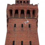 Torchbearer Alan Ellinson abseils with the Olympic Flame down the side of the Royal Dock Tower in Grimsby at the beginning of Day 40 of the London 2012 Olympic Torch Relay. (Gareth Fuller/LOCOG/PA Images)