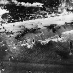 Men and assault vehicles storm the beach as Allied landing craft head ashore during the 6 June 1944 Normandy operation in France. (AP Photo)