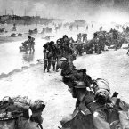 Wounded British troops from the South Lancashire and Middlesex regiments are helped ashore at Sword Beach during the D-Day invasion. (AP Photo)