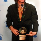 Paul McCartney with 1989 Life Achievement award presented to him at the 32nd annual Grammy Awards in Los Angeles, 22 February, 1990. (AP Photo/Douglas Pizac)