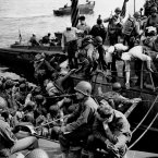 Men and supplies are ferried out to landing crafts en route to the initial Allied invasion of Normandy. (AP Photo/Peter Carroll)