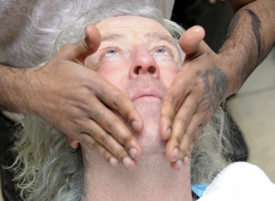 Mick Wallace taking time out from his business woes to get a shave
