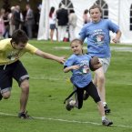 Nine-year-old Meghan Harris from Washington DC, the smallest player on the field, running away from would-be tacklers during the Football Classic.