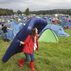 One festival-goes carrying her bed through the campsite. (Photo: Tony Kinlan)