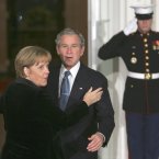 An awkward mid-embrace pause between George W Bush and Angela Merkel back in 2008. It's going to be hard to get that hug back on track. (AP Photo/Lawrence Jackson/PA Wire)