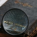 Auctioneer Paul Fairweather takes a closer look at a sixteen hundred page bible that used to belong to Elvis Presley, at Omega Auctions in Stockport. (David Thompson/PA Images)