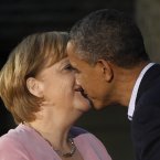 President Barack Obama and German Chancellor Angela Merkel get friendly at the G8 Summit in May. (AP Photo/Charles Dharapak/PA)