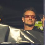 Bono wathes his friend Gavin Friday performing at the Electric Picnic this evening. (Photo: Andres Poveda)