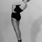 Mimicking Betty Grable's famous World War II pin-up pose. (AP Photo, File)