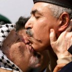 We're not sure how well Palestinian leader Yasser Arafat and Gaza's deputy commander of police Salim Al-Bourdani had choreographed this July 2000 greeting/smoochfest. (AP Photo/Lefteris Pitarakis/PA)