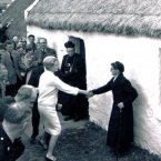 Grace Kelly shakes hand of local woman while visiting Newport in 1961.