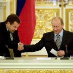 The gold-trimmed surroundings don't really distract from the awkward body language of this hunched-handshake between Russian President Vladimir Putin and then-First Deputy Premier Dmitry Medvedev in 2008. (AP Photo/Alexander Zemlianichenko, Pool)