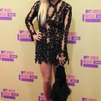 Controversial Ke$ha appears to have some kind of black plant growing over her body. Should we tell her or will you...? (Image: Doug Peters/EMPICS Entertainment)