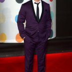 Robbie Williams knows how to wear a suit. Even a purple one. Doug Peters/EMPICS Entertainment