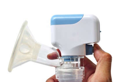 An electric breast pump, held at the ready.