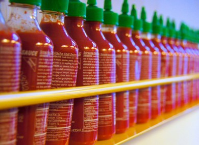 Sriracha bottles lined up in a restaurant.