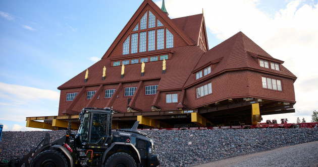A century-old Swedish church has arrived at its new home - three miles down the road